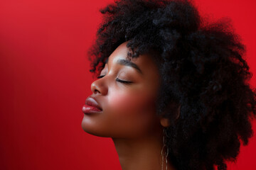 Fototapeta premium A close up of a black woman's face with her eyes closed looking to a side