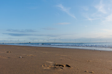 Beach in Holland with Wind Power Stations in the Sea