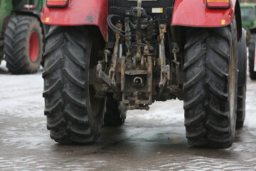 Rear view of the tractor with huge rear wheels.