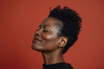A close up of a black woman's face with her eyes closed looking to a side