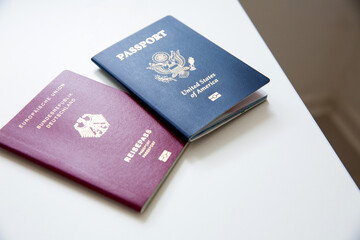 Close up of an American and German passports on white table