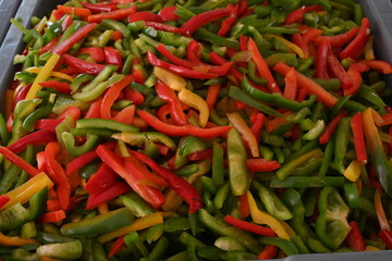 pimientos de tres colores, rojo, verde y amarillo en rajas
