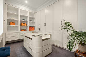 A luxurious and elegant walk in robe in a beautiful house. 