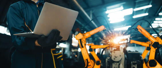 MLB Engineer use advanced robotic software to control industry robot arm in factory. Automation...