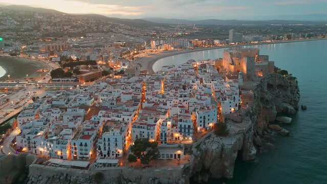 Aerial view of Peniscola beach and castle at twilight on Costa del Azahar, Spain