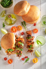 Hot grilled shashlik with bun baked on a grilled.