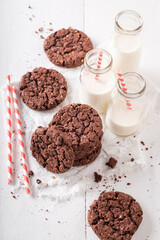 Delicious and crunchy brown cookies served with milk in bottle.