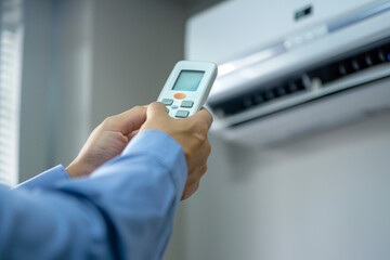 Hand Holding Remote Control for Air Conditioner