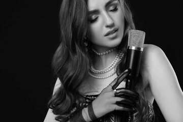 Beautiful singer with microphone, black and white effect