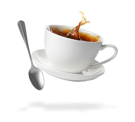 Cup of coffee, saucer and spoon in air on white background