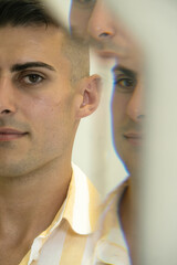 multiple mirror reflection portrait of sexy black haired male model