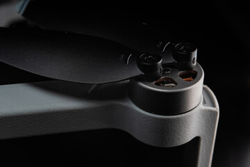 Detailed view of a metal object, specifically drone propellers, in low light conditions for a...