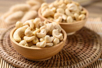 Raw cashew nuts in wooden bowl, Food ingredient