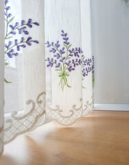 Embroidered window curtain with purple lavender bouquets, closeup detail with copy space. Concept of home decor, slow living, interior design, cottage core, rustic home decor, french home decor