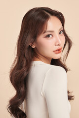 Beautiful young asian woman with clean fresh skin on beige background, Face care, Facial treatment,...