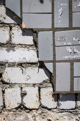 Decorative, facing tiles fell off the brick wall.
The destroyed wall, the consequences of the war