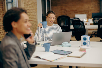 Young female business people working together in a coworking office