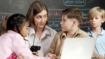 Caucasian boy using laptop programing engineering code and writing program while young caucasian...