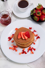Stack of pancakes hotcakes with honey and strawberries breakfast food american style