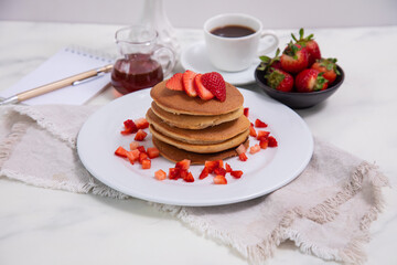 Stack of pancakes hotcakes with honey and strawberries breakfast food american style