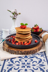 Stack of pancakes hotcakes with honey and strawberries breakfast food american style
