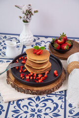 Stack of pancakes hotcakes with honey and strawberries breakfast food american style