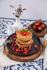 Stack of pancakes hotcakes with honey and strawberries breakfast food american style