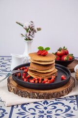 Stack of pancakes hotcakes with honey and strawberries breakfast food american style