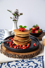 Stack of pancakes hotcakes with honey and strawberries breakfast food american style
