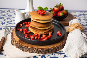 Stack of pancakes hotcakes with honey and strawberries breakfast food american style