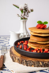 Stack of pancakes hotcakes with honey and strawberries breakfast food american style
