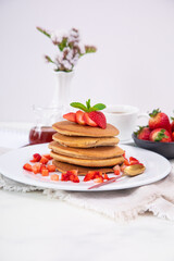 Stack of pancakes hotcakes with honey and strawberries breakfast food american style