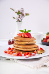 Stack of pancakes hotcakes with honey and strawberries breakfast food american style