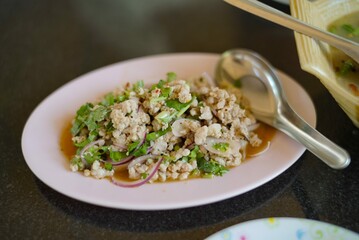 spicy minced pork salad in pink plate