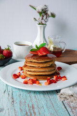 Stack of pancakes hotcakes with honey and strawberries breakfast food american style
