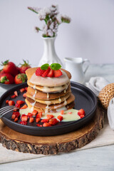 Stack of pancakes hotcakes with honey and strawberries breakfast food american style
