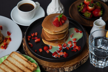 Stack of pancakes hotcakes with honey and strawberries breakfast food american style
