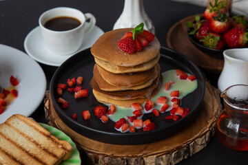Stack of pancakes hotcakes with honey and strawberries breakfast food american style