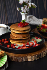 Stack of pancakes hotcakes with honey and strawberries breakfast food american style
