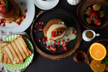 Stack of pancakes hotcakes with honey and strawberries breakfast food american style