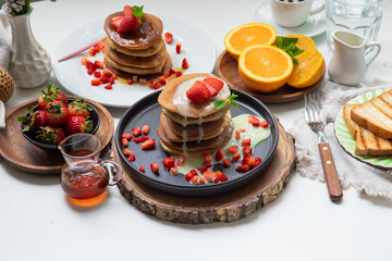 Stack of pancakes hotcakes with honey and strawberries breakfast food american style