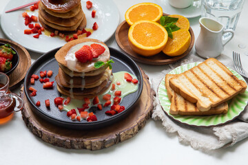 Stack of pancakes hotcakes with honey and strawberries breakfast food american style