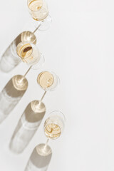 Full White wine glasses Minimal style above view. Holiday aesthetic still life photo, top view...