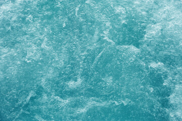 Bubbling water texture, flow thermal water as abstract background macro photo, spa and wellness theme, gentle ripples and gurgling on white turquoise aquatic surface, sea color gradient