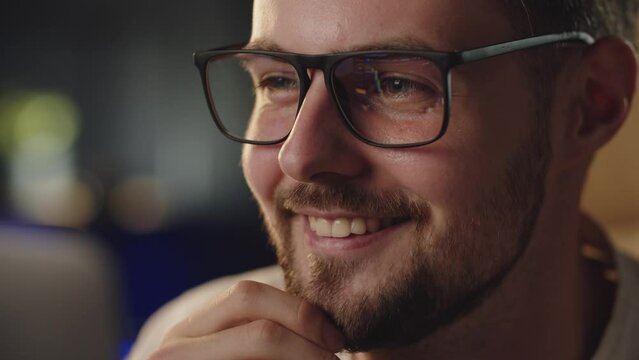 Businessman analyzing stock market. Expert trader man focused looking at growing his shares prices increasing in eyeglasses reflection. Thoughtful crypto investor likes when graphic goes up