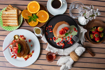 Stack of pancakes hotcakes with honey and strawberries breakfast food american style