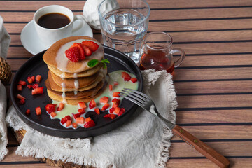 Stack of pancakes hotcakes with honey and strawberries breakfast food american style