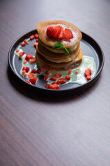 Stack of pancakes hotcakes with honey and strawberries breakfast food american style