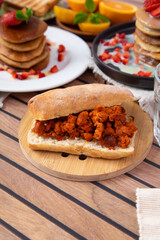 Breakfast table full of food brunch pancakes, bread and fruit