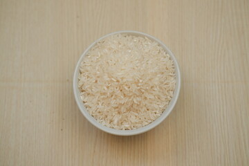 A bowl of rice on a wooden table